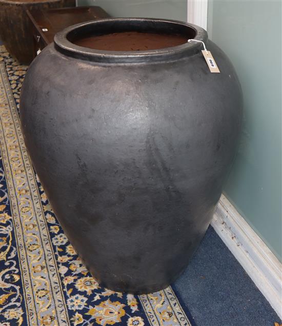 A gun metal glazed pottery garden urn H.84cm